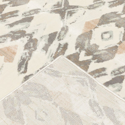 Ivory, pink, and sage geometric-pattern area rug with a stitched corner edge.