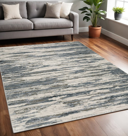 5' X 8' Blue Grey Beige And Brown Abstract Power Loom Stain Resistant Area Rug