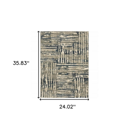 Rectangular area rug with abstract patchwork pattern in beige, gray and blue tones; 35.83" x 24.02