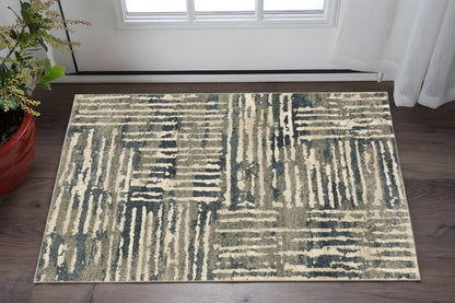 Rectangular abstract area rug in beige, gray & blue-gray with linear geometric blocks; modern neutral living room decor.