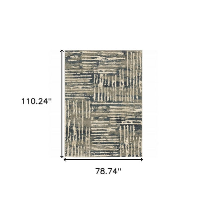 Rectangular rug in beige, gray & blue patchwork; abstract striped blocks; 110.24" x 78.74".