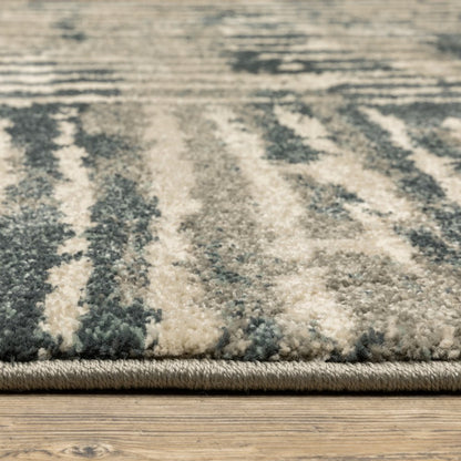 Close-up of a blue-gray and cream shag area rug edge on a wooden floor.