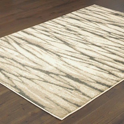 Rectangular ivory and sand shag rug with an abstract pattern on dark wood floor.