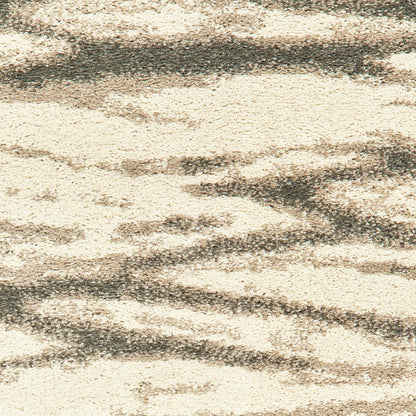 Ivory and sand abstract shag area rug with textured surface.
