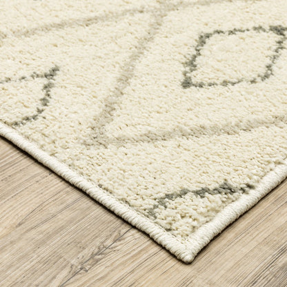Cream textured rug with light gray geometric pattern on a light wood floor.