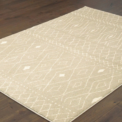 Beige shag area rug with cream geometric pattern on dark wood floor.