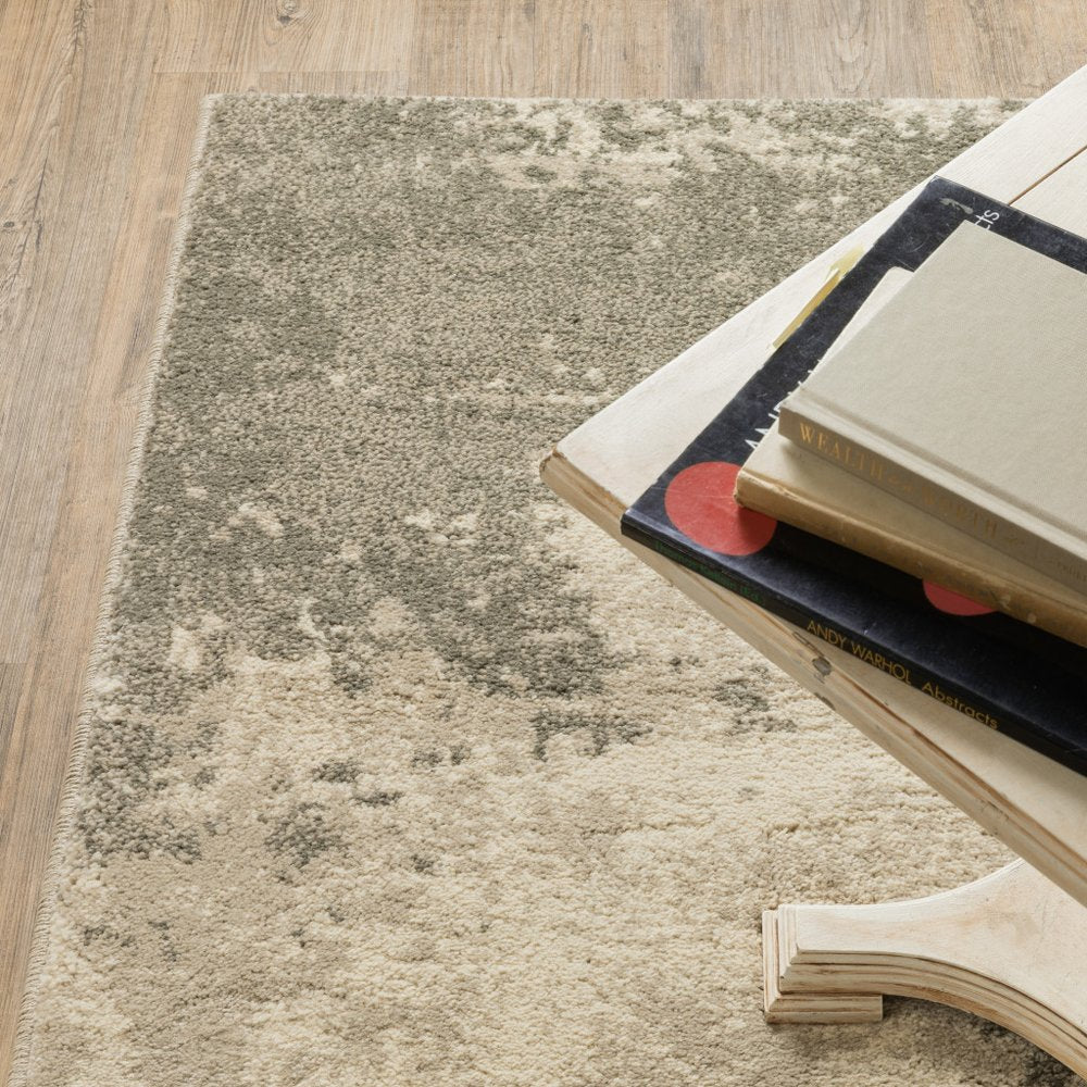 Beige-gray distressed rug on light wood floor; curved wooden table leg with a stack of hardcover books on top.