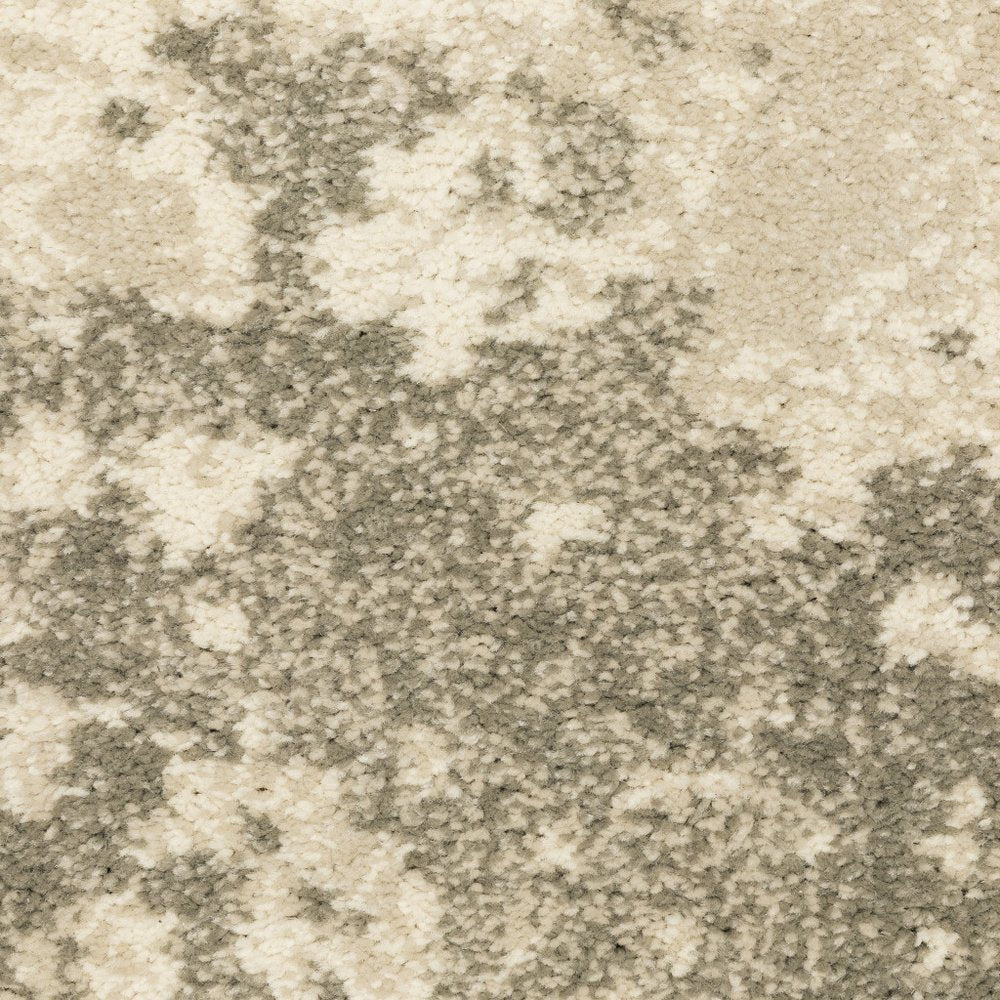 Soft plush area rug in beige and gray with an abstract cloud-like pattern.
