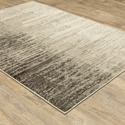 Rectangular area rug with cream & brown gradient, soft textured pile, modern abstract style on light wood floor.