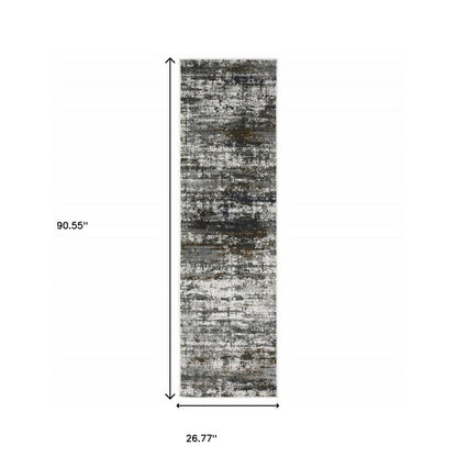 2' x 8' runner rug in ivory, charcoal grey, blue, rust and brown with an abstract power-loom design; stain resistant.