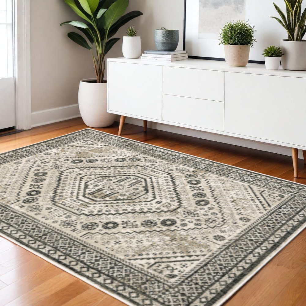 Beige-gray geometric area rug on wood floor beside a white mid-century modern sideboard with potted plants.