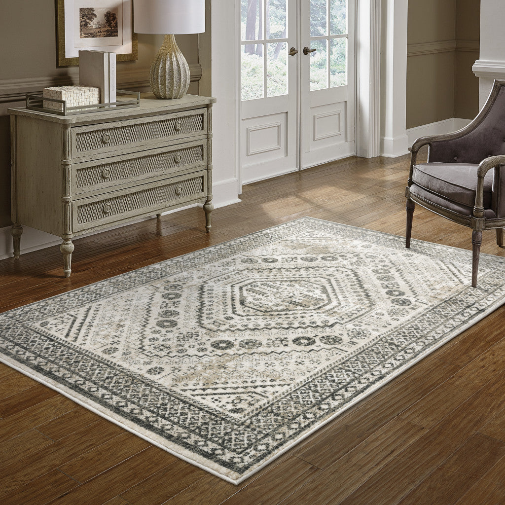 5' X 7' Ivory Grey Black And Ivory Oriental Power Loom Stain Resistant Area Rug