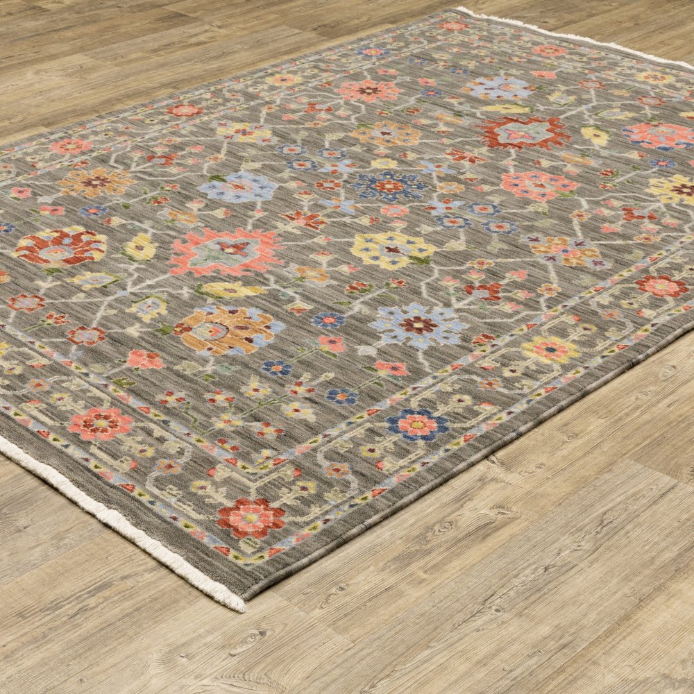 6' X 9' Grey Salmon Pink Gold Blue Rust Deep Blue Ivory And Green Oriental Power Loom Stain Resistant Area Rug With Fringe