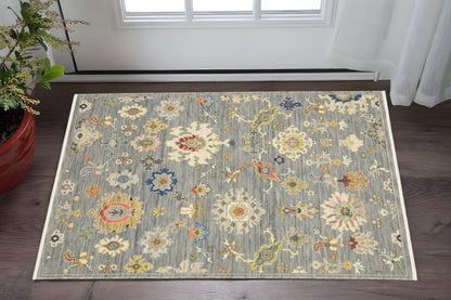 3' X 5' Grey Ivory Gold Salmon Red Blue And Green Oriental Power Loom Stain Resistant Area Rug With Fringe
