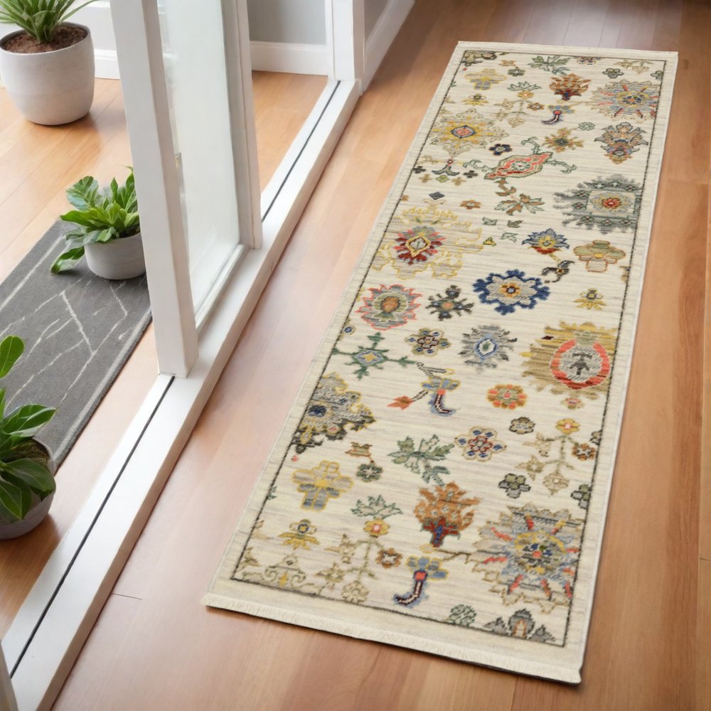 2' x 6' oriental power loom stain resistant runner rug with fringe in ivory, beige, gold, grey, blue, pink, red, rust and green.