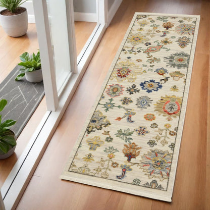 2' x 6' oriental power loom stain resistant runner rug with fringe in ivory, beige, gold, grey, blue, pink, red, rust and green.