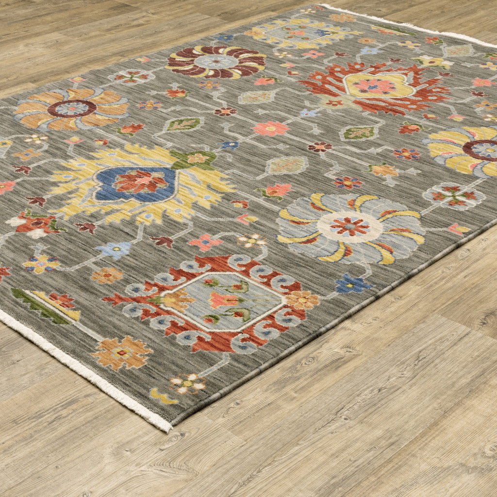 5' X 8' Grey Charcoal Yellow Blue Rust Red Pink Green And Ivory Oriental Power Loom Stain Resistant Area Rug With Fringe