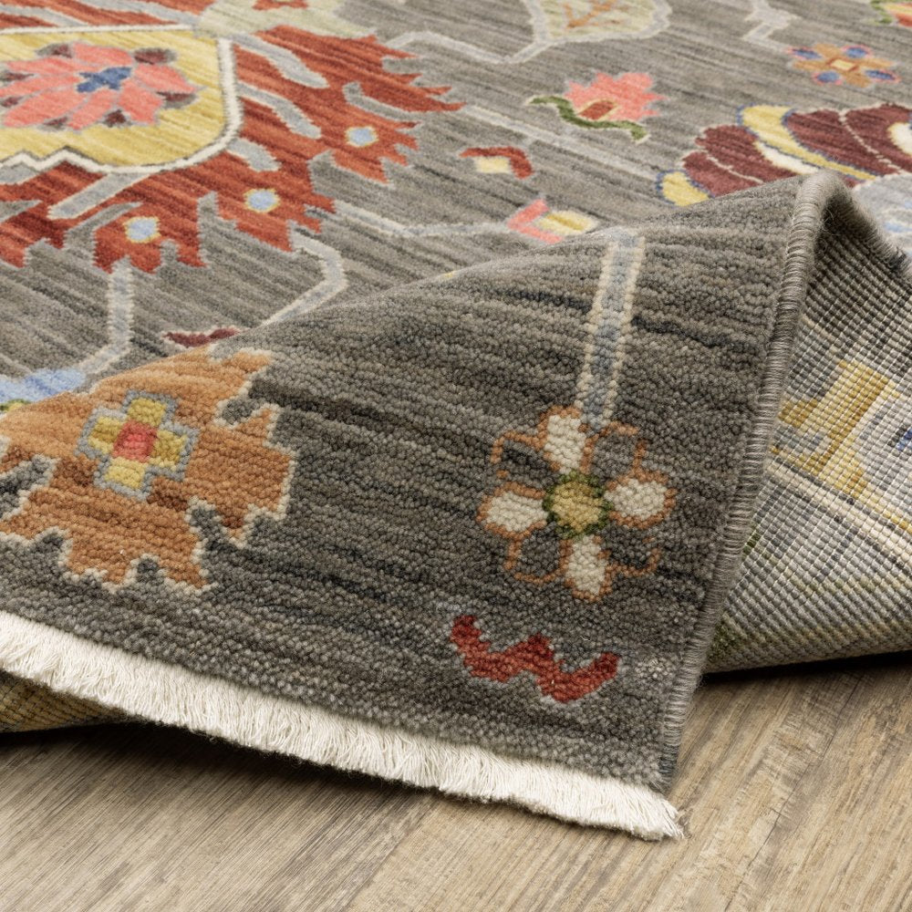 8' x 11' Oriental area rug with fringe; grey charcoal, yellow, blue, rust, red, pink, green and ivory; stain resistant, power loom.