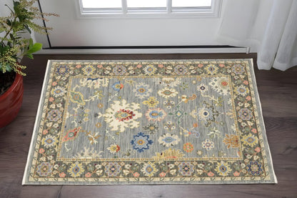 3' X 5' Blue Grey Gold Green Pink Orange Ivory And Red Oriental Power Loom Stain Resistant Area Rug With Fringe