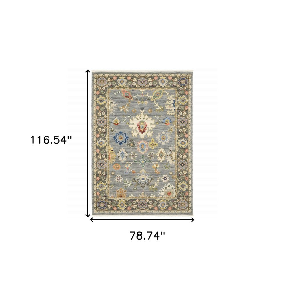 6' x 9' Oriental power loom area rug in blue, grey, gold, green, pink, orange, ivory and red with fringe; stain resistant.