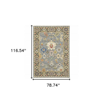 6' x 9' Oriental power loom area rug in blue, grey, gold, green, pink, orange, ivory and red with fringe; stain resistant.