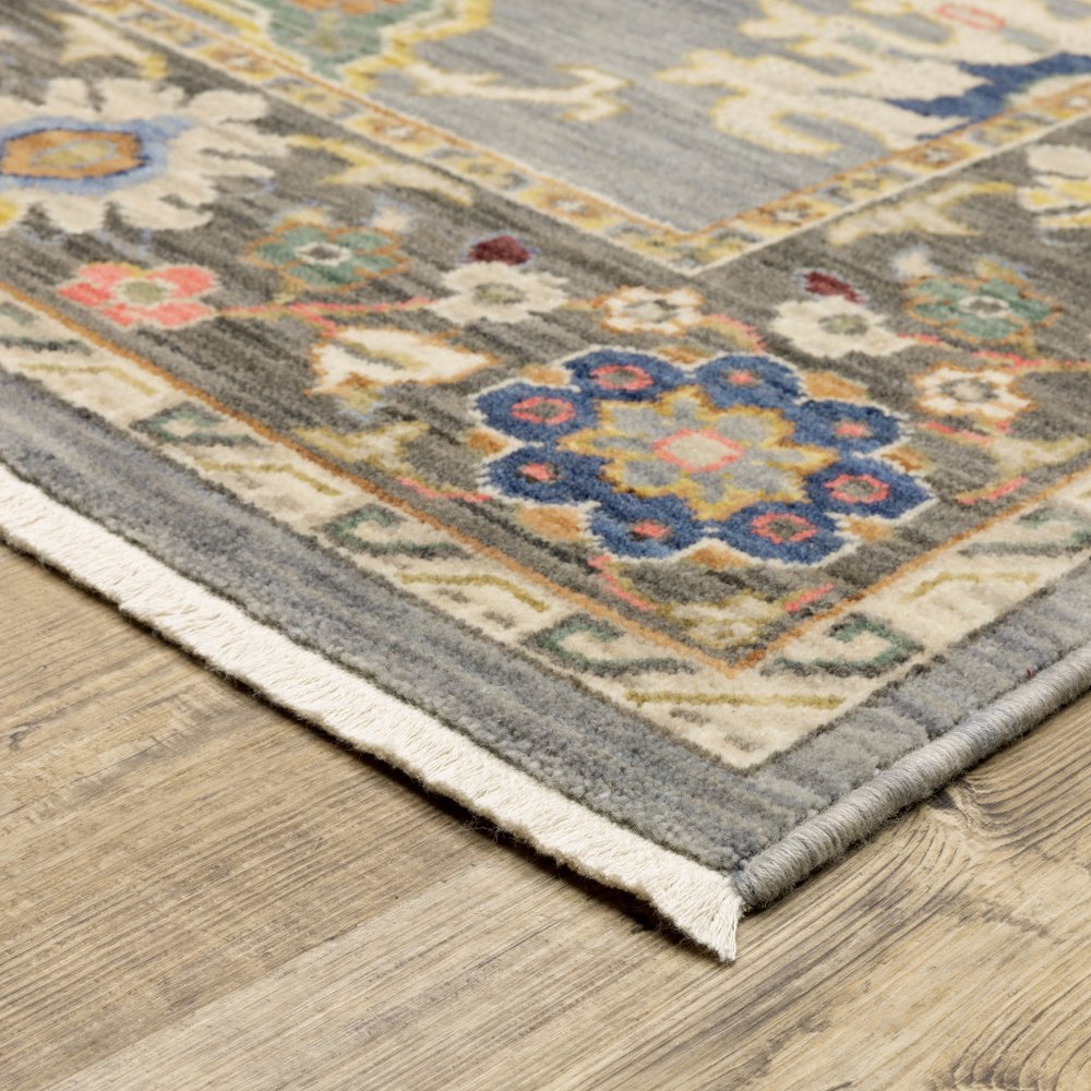 6' x 9' blue gray gold green pink orange ivory and red oriental power loom stain resistant area rug with fringe