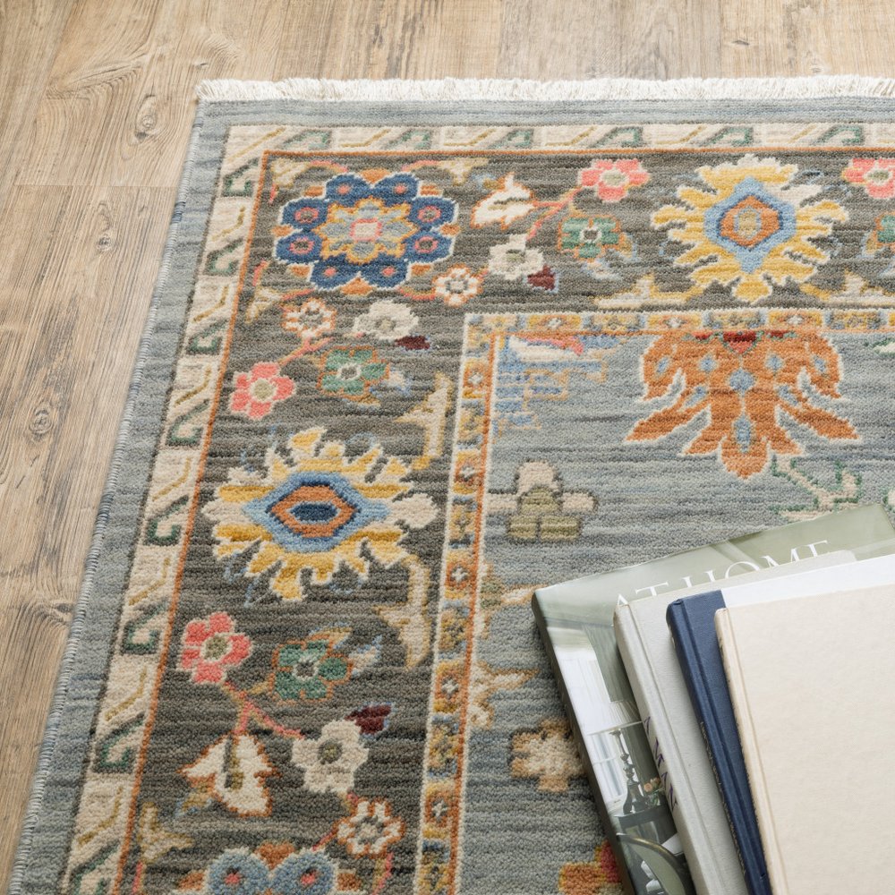 6' X 9' Blue Grey Gold Green Pink Orange Ivory And Red Oriental Power Loom Stain Resistant Area Rug With Fringe