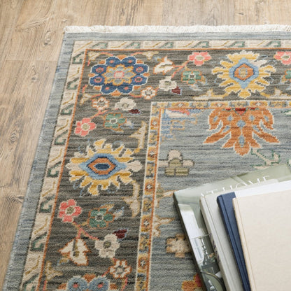 6' X 9' Blue Grey Gold Green Pink Orange Ivory And Red Oriental Power Loom Stain Resistant Area Rug With Fringe