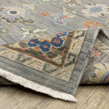 6' X 9' Blue Grey Gold Green Pink Orange Ivory And Red Oriental Power Loom Stain Resistant Area Rug With Fringe
