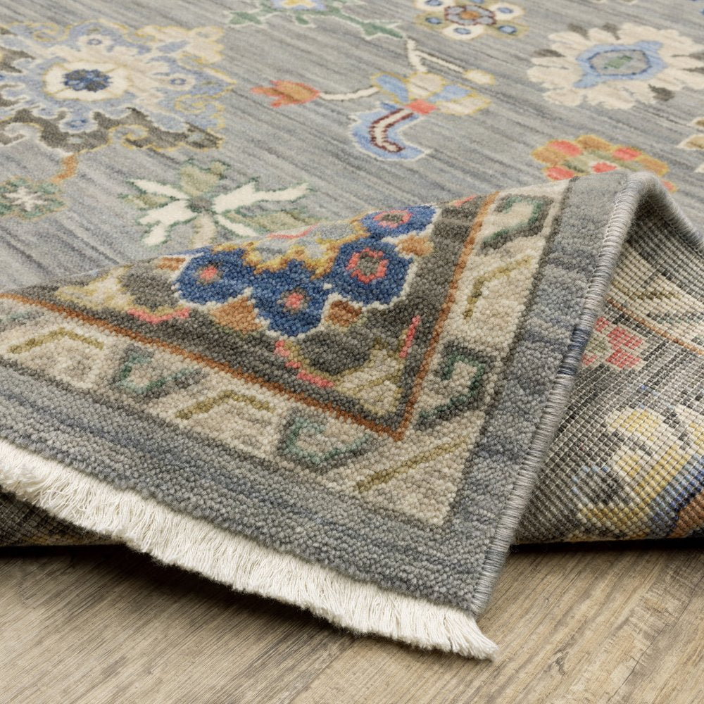 6' X 9' Blue Grey Gold Green Pink Orange Ivory And Red Oriental Power Loom Stain Resistant Area Rug With Fringe