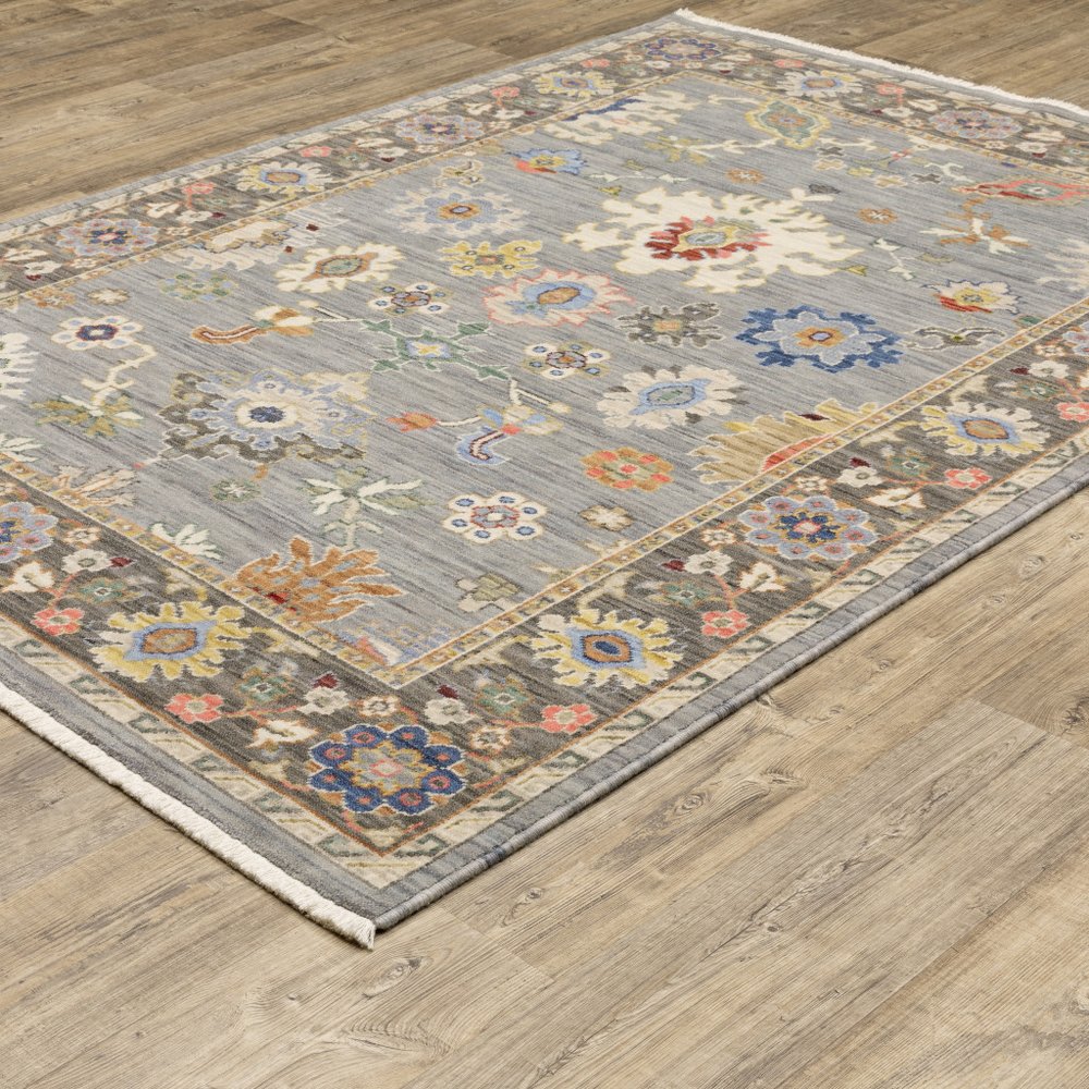 8' x 11' oriental power loom area rug with fringe; stain resistant; colors include blue, gray, gold, green, pink, orange, ivory, and red.