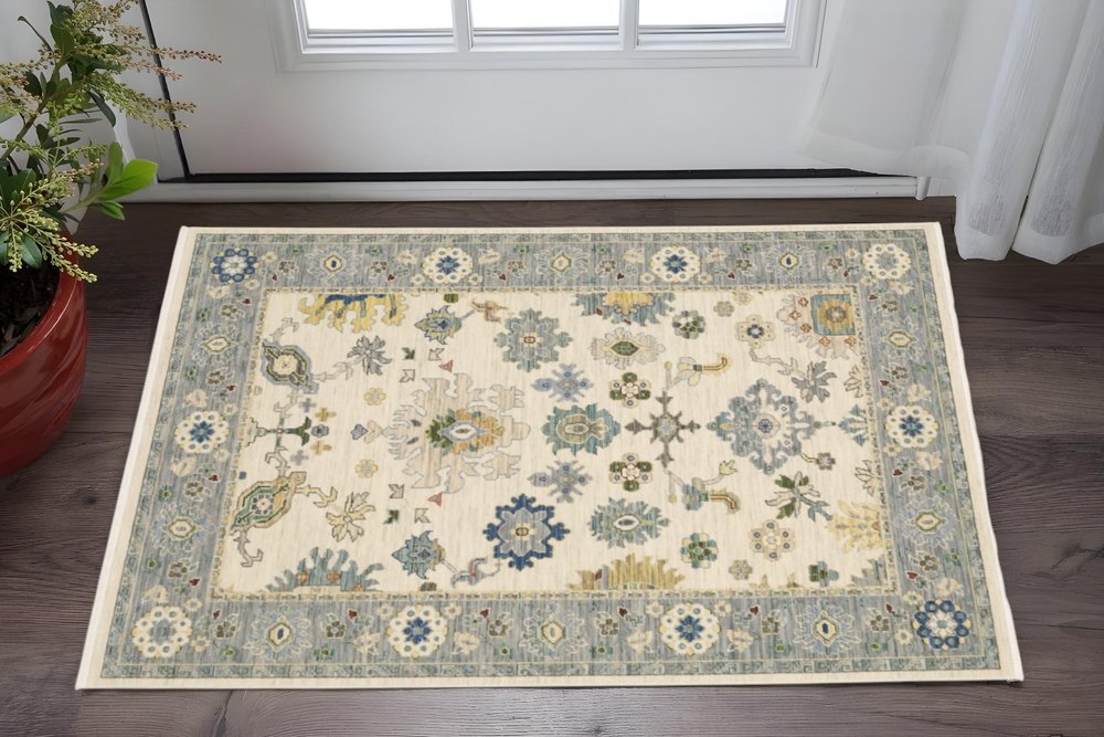 3' X 5' Ivory Blue Grey Teal Gold Green And Rust Oriental Power Loom Stain Resistant Area Rug With Fringe