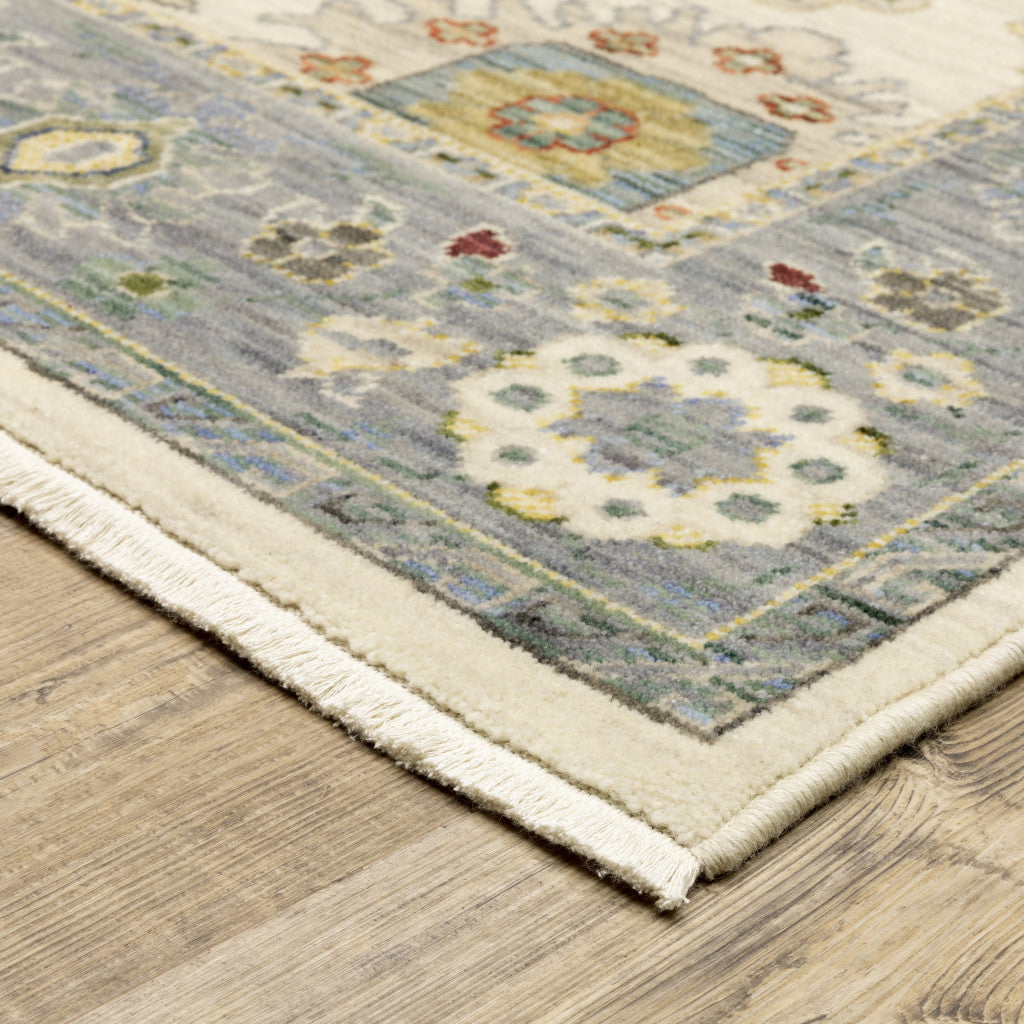 5' X 8' Ivory Blue Grey Teal Gold Green And Rust Oriental Power Loom Stain Resistant Area Rug With Fringe