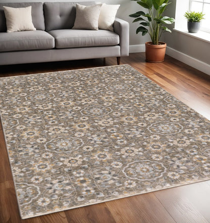 5' X 8' Grey And Tan Floral Power Loom Stain Resistant Area Rug With Fringe