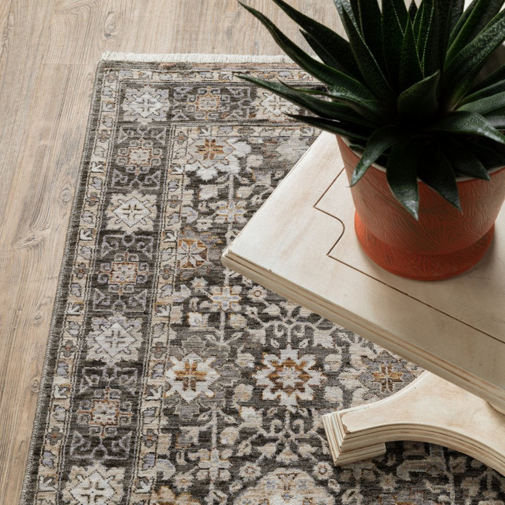 8' X 11' Charcoal Ivory and Beige Floral Power Loom Area Rug With Fringe
