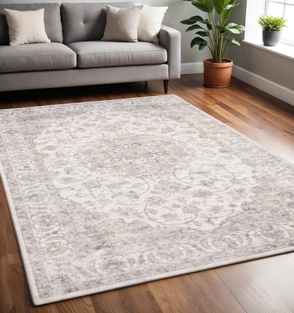5' X 7' Beige Gold And Grey Oriental Power Loom Stain Resistant Area Rug