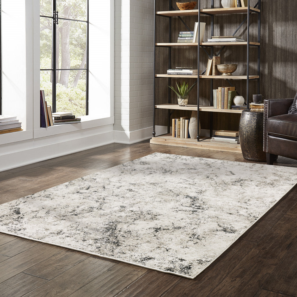 5' X 8' Ivory Grey Black Beige And Tan Abstract Power Loom Stain Resistant Area Rug