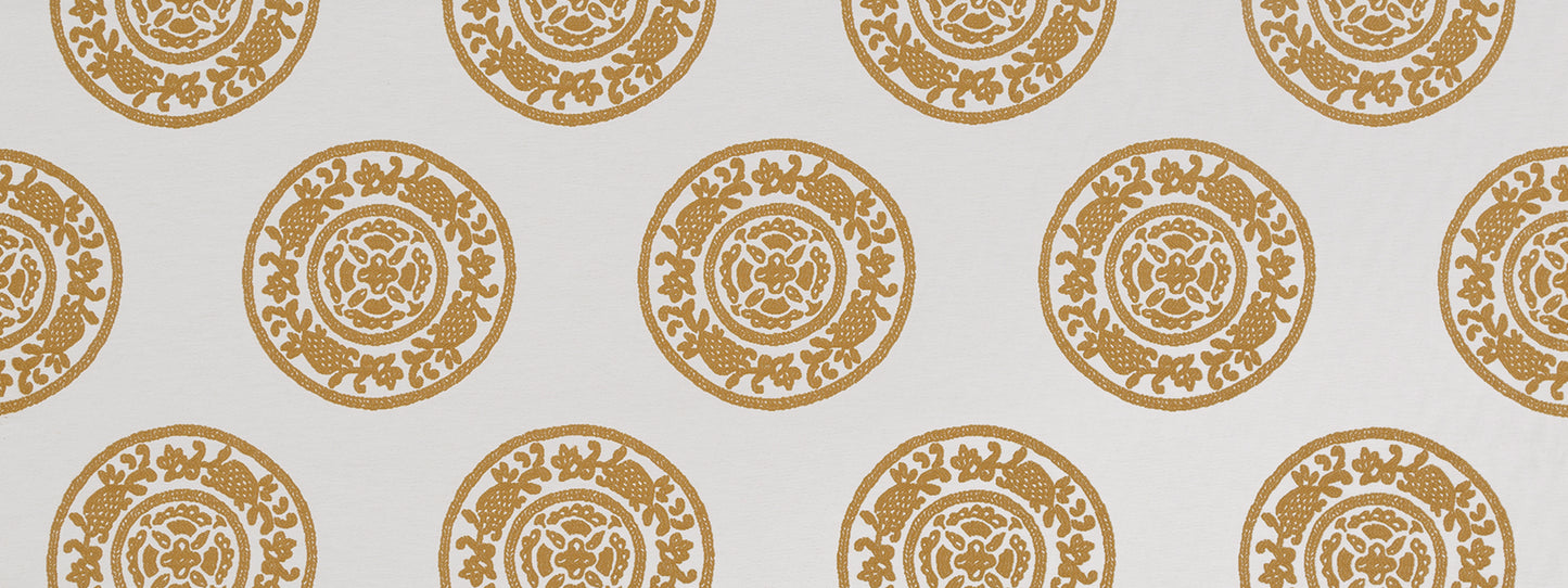 Gold circular rosette medallion pattern repeating on butternut background.