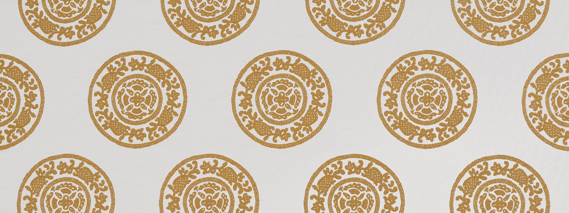 Gold circular rosette medallion pattern repeating on butternut background.
