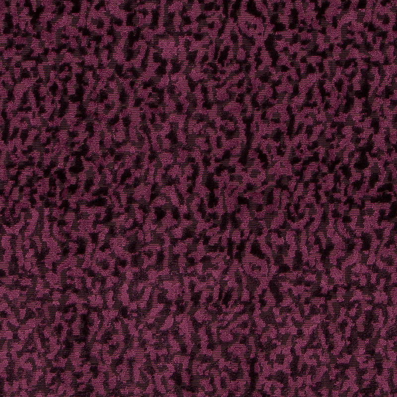 Plush plum leopard-spot upholstery fabric with black irregular spots and a soft velvety texture.