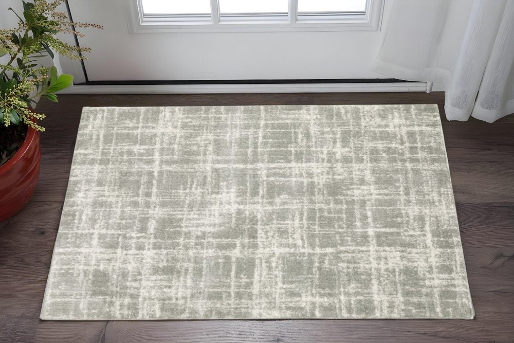 2' X 3' grey and ivory abstract shag area rug with power loom construction and stain resistance.