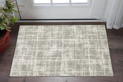 2' X 3' grey and ivory abstract shag area rug with power loom construction and stain resistance.