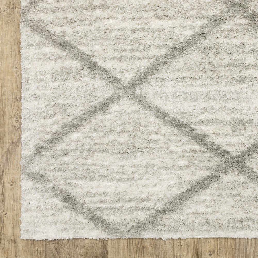 2' X 3' ivory and grey geometric shag area rug with power loom construction and stain resistance