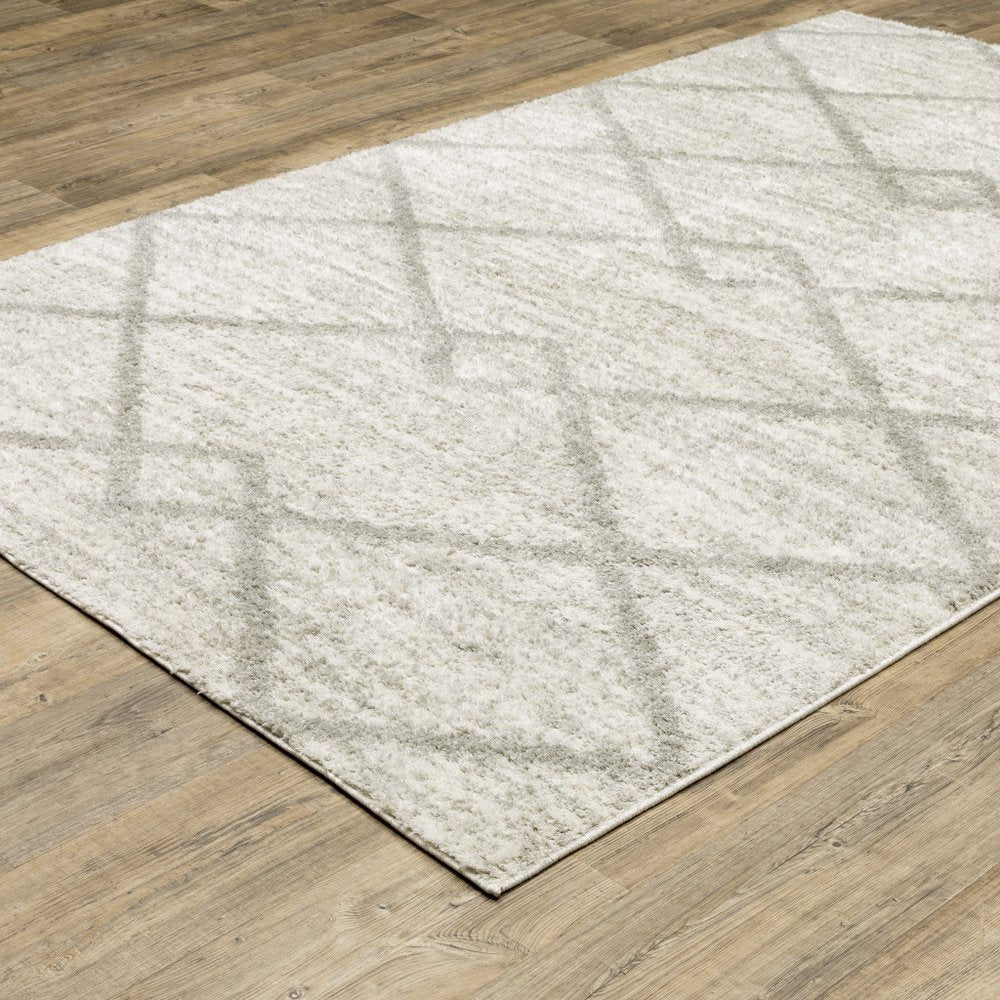 5' x 8' ivory and grey geometric shag power loom stain resistant area rug