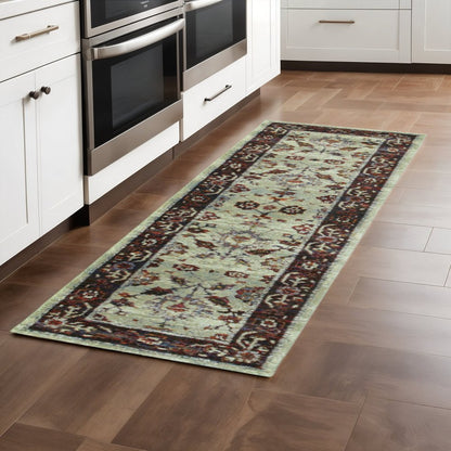 Red and ivory oriental runner rug, 8' long, placed in a white kitchen with stainless steel ovens.