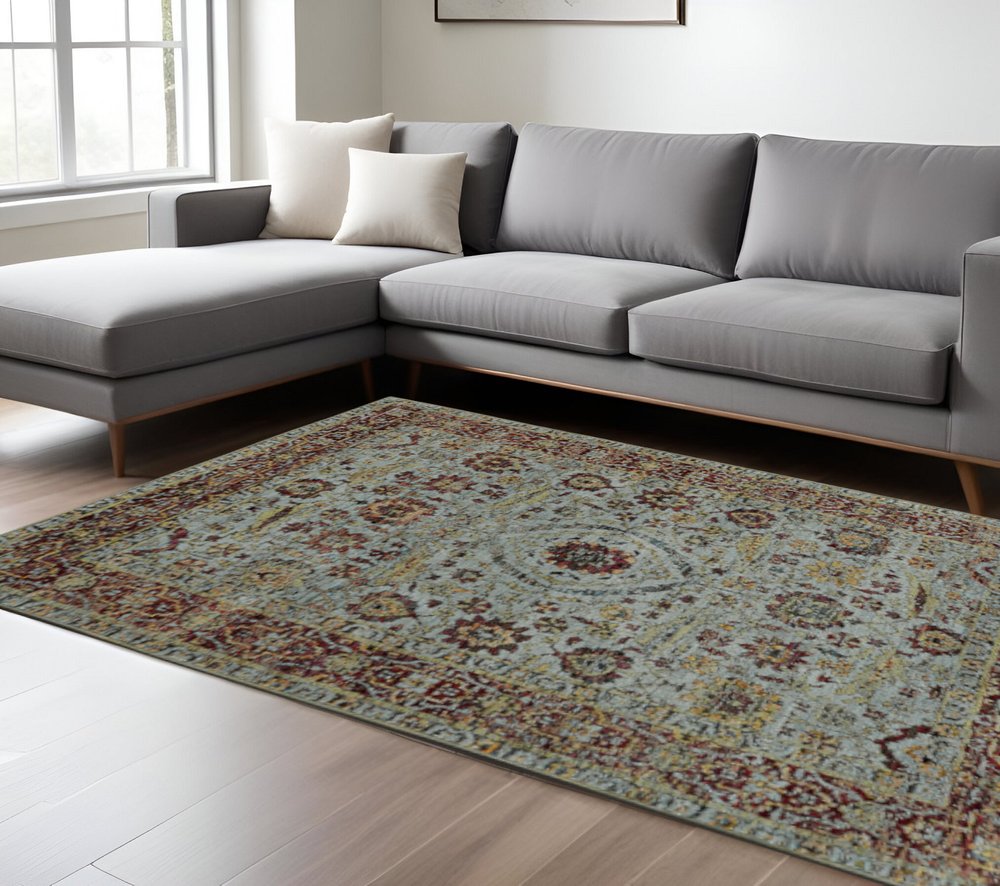 Blue and green oriental power loom area rug, 10' x 13', in a bright living room.