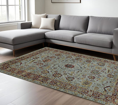 Blue and green oriental power loom area rug, 10' x 13', in a bright living room.
