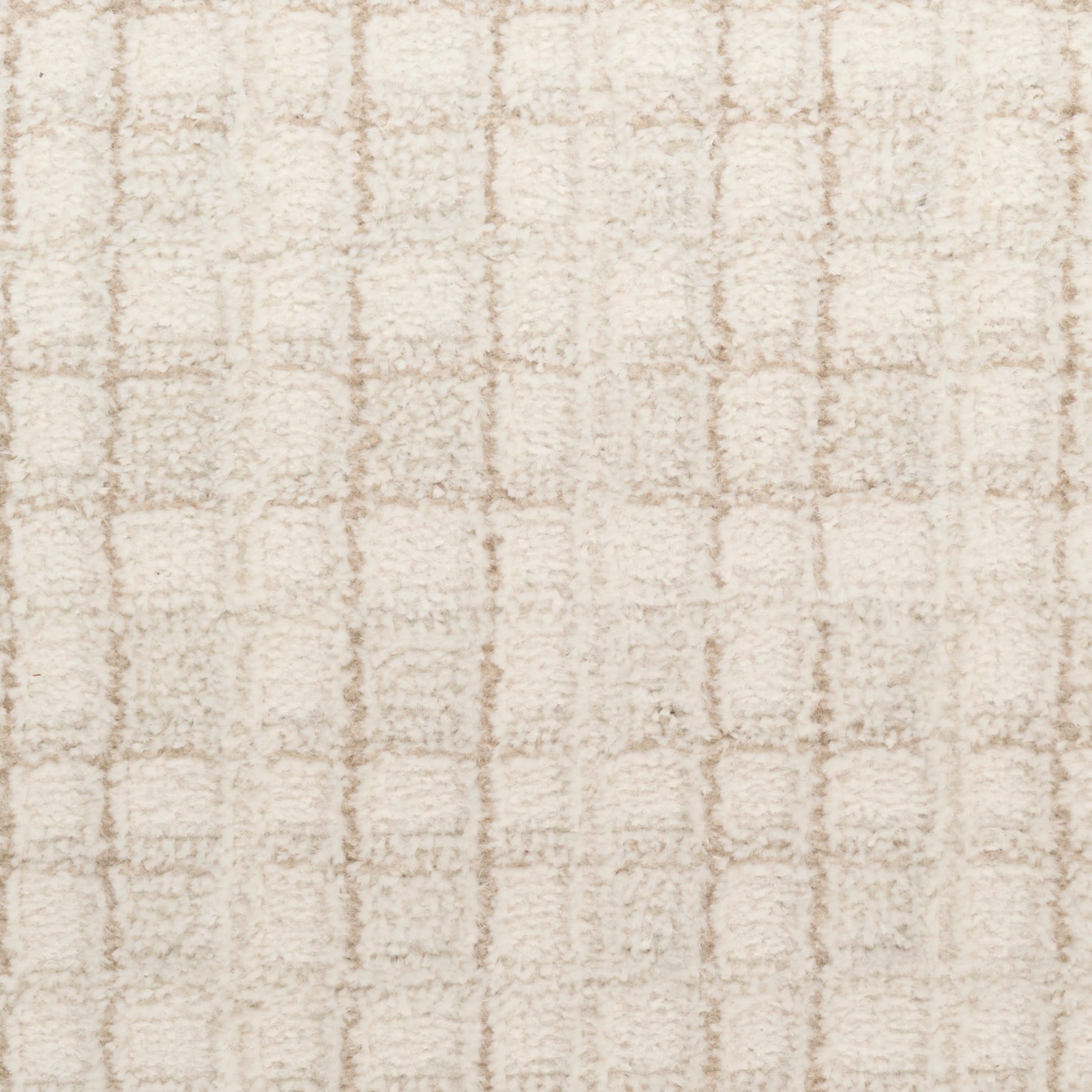 Beige shag rug with soft plush pile and a subtle square grid pattern.