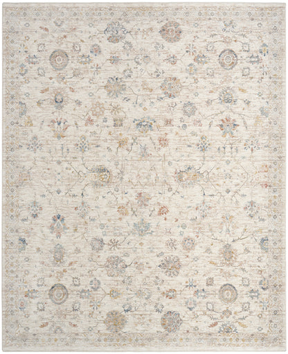 Soft beige distressed area rug with faded floral medallion motifs in blue, gray & tan; rectangular, vintage-inspired.