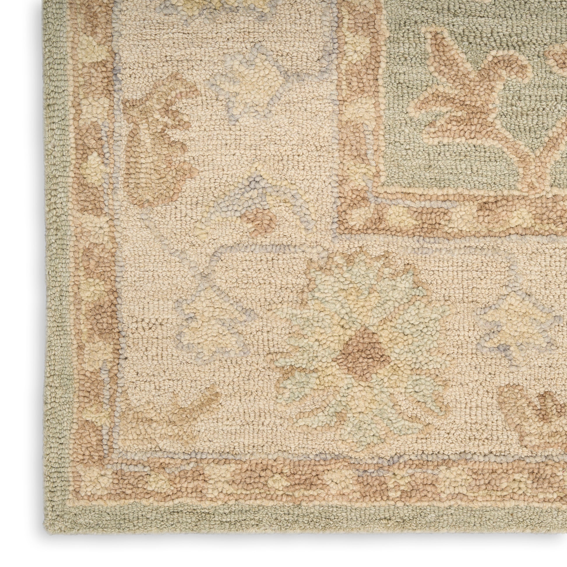 Close-up of a cream textured rug corner with pastel floral motifs, tan border and soft blue accents.